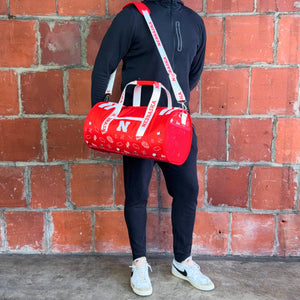 Man-Standing-With-University-of-Nebraska-Duffle-Bag