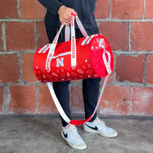 Man-Holding-University-of-Nebraska-Duffle-Bag