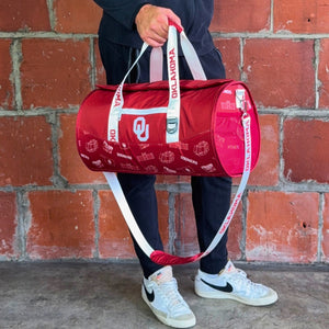 Man-Holding-University-of-Oklahoma-Duffle-Bag