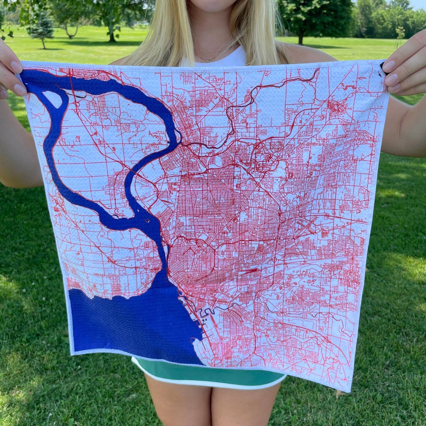 A lady showing Magnetic Golf Towel - Buffalo Map