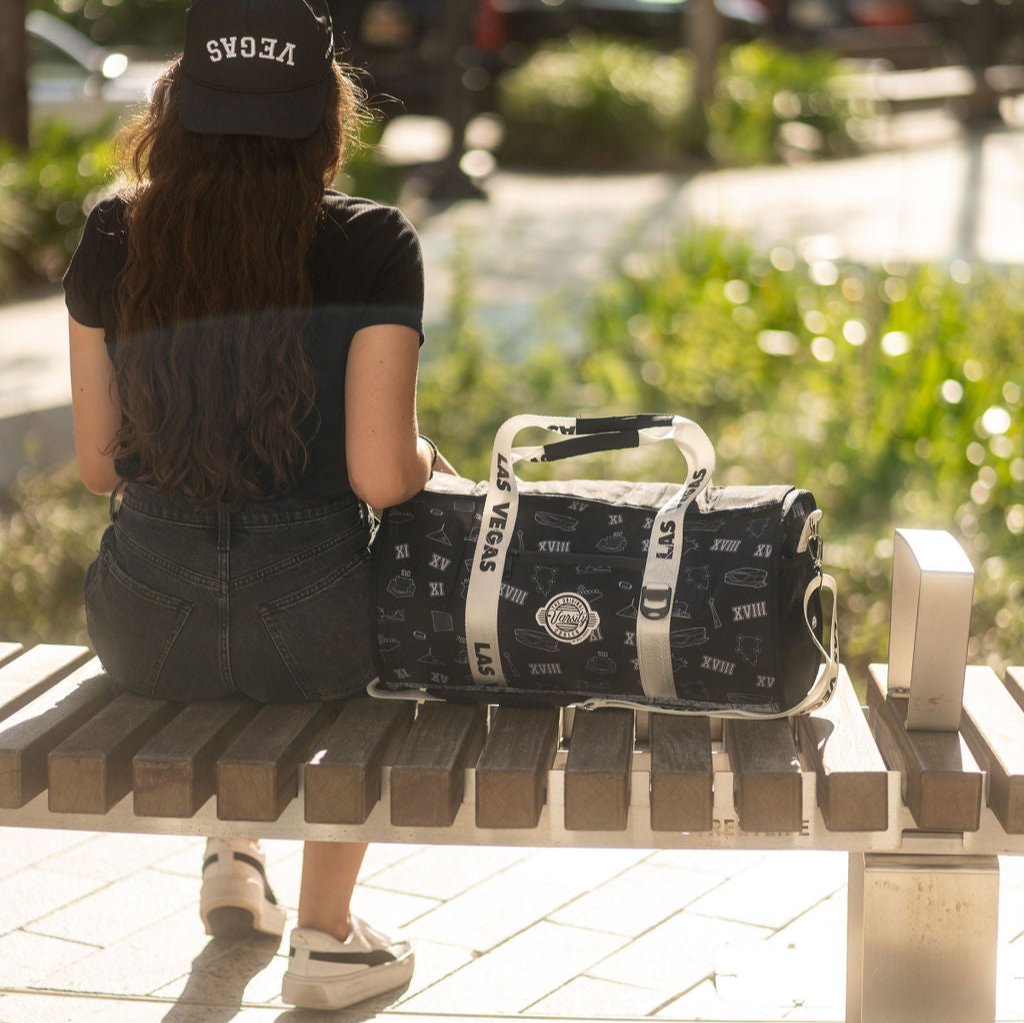 Girl sitting beside the duffle bag cooler