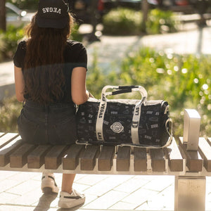 Girl-sitting-beside-the-duffle-bag-cooler