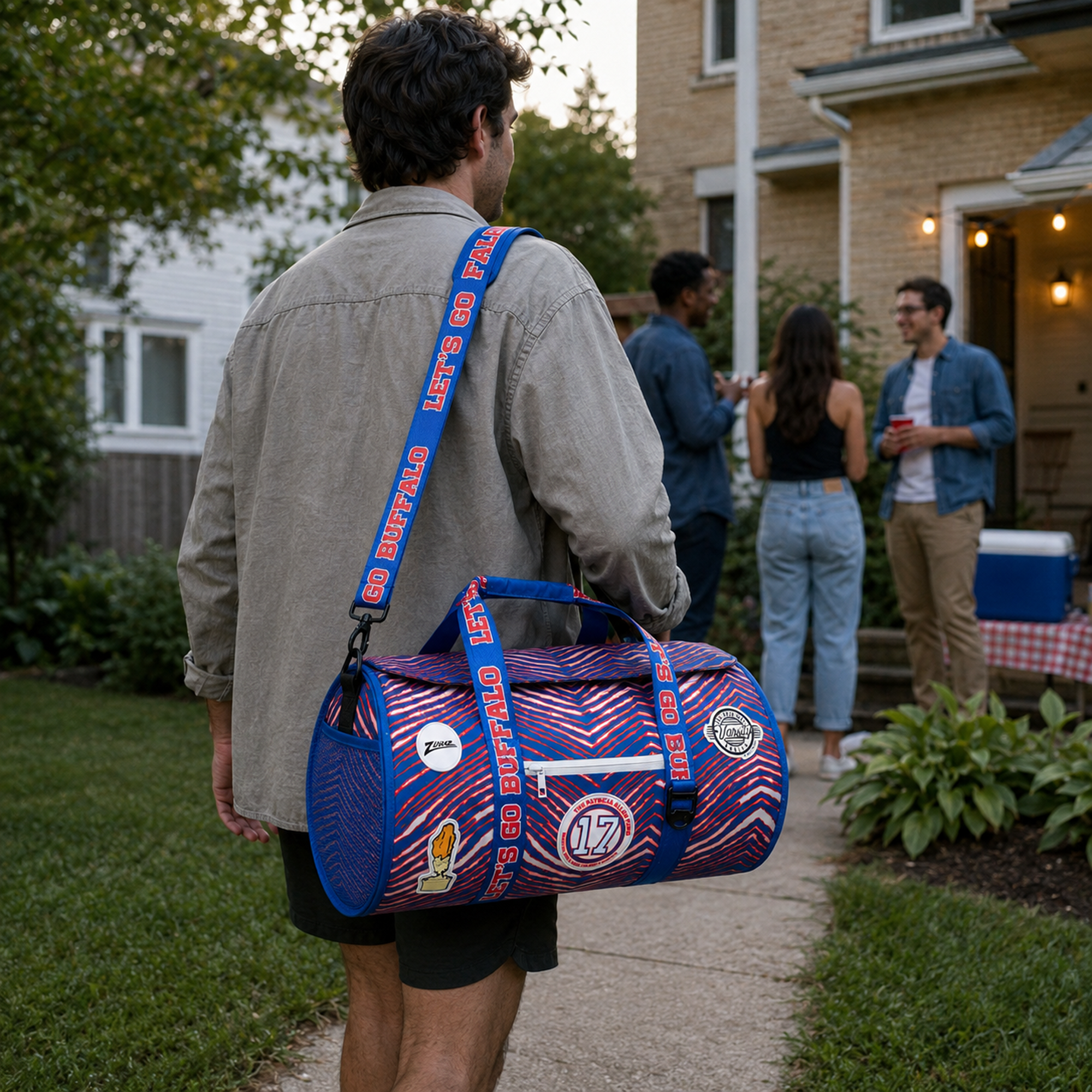 Man-carrying-the-Buffalo-Zubaz-Duffel-Cooler-by-its-removable-shoulder-strap-to-an-outdoor-gathering
