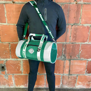 Man-standing-with-carry-on-duffel-bag