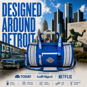 A-blue-and-white-striped-golf-duffel-bag-with-'DETROIT'-printed-repeatedly-on-the-straps,-set-against-a-Detroit-cityscape-background-with-a-blue-car,-skyscrapers,-and-a-statue.-Large-text-reads-'DESIGNED-AROUND-DETROIT,'-and-a-bottom-banner-lists-featured-media-including-Today,-Golf-Digest,-and-Netflix.