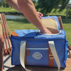Golfer reaches from the cart seat, opens the magnetic flap and removes a cold drink from the Course Cruiser.