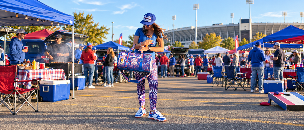 Buffalo fan carrying a Varsity duffel cooler at a stadium tailgate